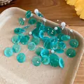 Detail shot of teal shell disc and pearl dangle earrings for summer beach vacation style - Pearl Shell Connected Style