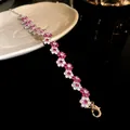 Detailed close-up of a silver bracelet featuring pink and white zircon flower clusters - Pink Flower Style / Silver