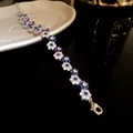 Close-up of elegant flower bracelet with sparkling blue and white cubic zirconia stones - Blue Floral / Silver