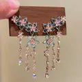 Close-up of blue zircon flower earrings with elegant tassels and gold chains - Silver Needle / Gold-Blue-Pink