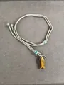 Handmade woven rope necklace with tiger eye stone fish pendant for a boho look - Brown