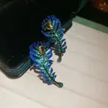 Detailed macro view of vintage peacock feather earrings inlaid with colorful sparkling zircon - Colorful Zirconia Feather Stud / Silver Needle / 11# Gunmetal Blue Green