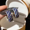 Detailed close-up of retro hoop earrings with blue and white pave-set zircons - Pave Wide Hoop Earring / Ear Buckle / Silver-Blue
