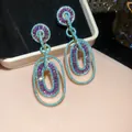 Close-up of luxury drop earrings featuring purple zircons and turquoise bead accents - Purple Zirconia Nested Double Ring / Silver Needle / 20# Gold Blue Purple