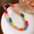 Close-up view of vibrant multi-colored marbled acrylic cylinder beads on a necklace - Necklace / Long Style / Colorful