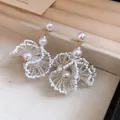 Gros plan de boucles d'oreilles fleurs en perles style français en boîte à bijoux - Boucles d'oreilles