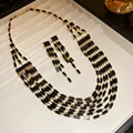 Close-up of vintage multi-layer necklace and earring set with black rectangular crystals - Black