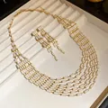 Detail view of vintage palace style necklace and earrings set with white rectangular tiles - White