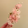 Close-up detail of pink fabric flower hair clip with elegant pearls and green beads accessory - Duckbill Clip (Single Piece) / Pink