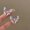 Close-up of elegant purple enamel butterfly earrings with delicate pearls and crystals. - Silver Post Butterfly Style (HE33833) / Purple