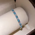 Close-up of elegant Evil Eye tennis bracelet with clear sparkling cubic zirconia. - Gold-Light Blue