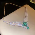 Macro view of luxurious 18k gold-plated necklace with sparkling emerald-cut zircon - Silver-Blue