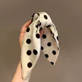 Close-up of elegant polka dot bow hair claw clip with silk-like texture - Hair Claw / White with Black Polka Dots