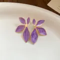 Macro detail of purple marbled enamel flower earrings with gold-toned metal plating - Purple