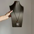 Ethnic retro flower necklace on black cord with vibrant orange bead accent for stylish layering - Hollow Flower / Silver