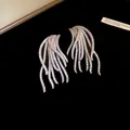 Stunning macro detail of 18k gold plated wing earrings with pavé set sparkling zircons - Silver