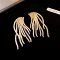Close-up detail of 18k gold plated vintage drop earrings with sparkling zircons - Gold