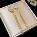 Elegant detail showing 18k gold plated flower stud earrings with sparkling zircon tassels - Flower Tassel (HE31485) / Gold