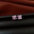 Macro view of elegant pink zircon flower stud earrings on a dark leather surface - Silver Earring Post - Silver - Purple