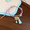 Handmade woven colorful rope bracelet with green butterfly charm and pearl tassel - Butterfly Design