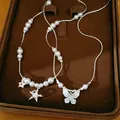 Collier de perles avec pendentifs étoile et papillon en zircon sur plateau velours. - Motif Papillon Étoile / Argent