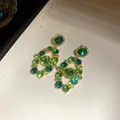 Macro view of vintage style emerald green rhinestone encrusted gold drop earrings - Earrings Only (Silver Earring Post) / Green