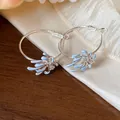 Detailed view of silver hoop earrings featuring blue enamel flower design and zircon - Flower Hoop (HE31554) / Blue