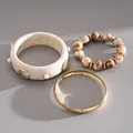 Detailed view of three-piece resin bracelet set with shell accents and marble beads - 3-Piece Bracelet Set / Gold-Ivory White