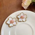 Close-up detail of elegant white enamel flower stud earrings with pink stamens - Style 1 Five-Petal Cherry Blossom