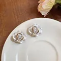Close-up of elegant white rose stud earrings with heart crystal and pearl details - Style 2 Camellia