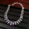 Close-up of a vintage purple zircon necklace with enamel detailing on a black tray. - Necklace / Silver-Purple