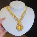 Detailed view of a luxury gold-tone necklace with sparkling yellow square zircons. - Necklace (HE34331) / Gold-Yellow