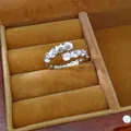 Macro detail of a silver-toned open ring with sparkling zircon and white resin beads. - Spiral Open Style / Silver