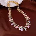 Detail of vintage gold-tone necklace with pink and purple zircon stones on brown fabric - Necklace / Gold-Pink-Lavender