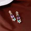 Close-up of vintage style gold earrings with purple teardrop crystals and green enamel - Silver Earring Post Earrings / Gold-Light Purple