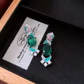 Detailed view of vintage-style earrings featuring emerald green stones and pink zircons - Silver Earring Post Earrings / Silver-Green