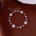 Elegant silver flower bracelet with sparkling cubic zirconia on burgundy silk background - Camellia Style / Silver