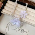 Detailed view of ethereal white pearl necklace with delicate fabric flowers and feathers - Necklace (HN11362) / White