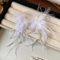 Detailed view of exquisite white feather flower earrings with delicate pearl tassels and beads. - Earrings (HE31429) / White