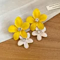 Macro detail of yellow and white enamel flower earrings with sparkling rhinestone center - Double Layer Flower / Yellow