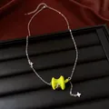 Close-up detail of silver chain necklace with glossy green apple pendant and star charms - Silver-Green