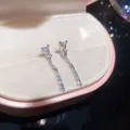 Minimalist silver-tone tassel earrings with sparkling zircon stones in a pink box. - Silver