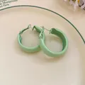 Close-up of light green spray-painted hoop earrings on a vintage cream ceramic plate - Small / Green