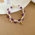 Close-up of elegant bracelet featuring purple amethyst beads, freshwater pearls, and a pinecone charm - 16# Bracelet-Purple-Amethyst Pine Cone