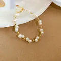 Close-up detail of a handmade freshwater pearl bracelet with elegant gold spacer beads - 17# Bracelet-Gold-Heart Pendant