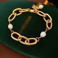 A detailed view of a gold link chain bracelet featuring natural white freshwater pearls - 21# Bracelet-Gold-Oval Chain