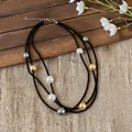 Detail of a multi-layer black beaded necklace with large pearls on a rustic background. - Three-layer Beaded Style / Necklace-Black