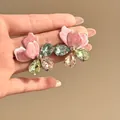 Close-up of oversized pink enamel and colorful crystal flower earrings held in hand - Flower With Silver Post (HE34201) / Pink and Green