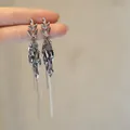 Detailed view of silver wheat ear tassel earrings with white zircon accents - Clip-On Earrings / Silver