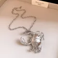 Macro view of oversized 3D crab pendant necklace with polished silver metallic finish - Necklace / Silver